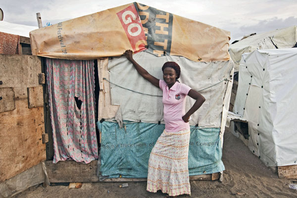Esther, the star of programme three, outside her house on the slum on the beach