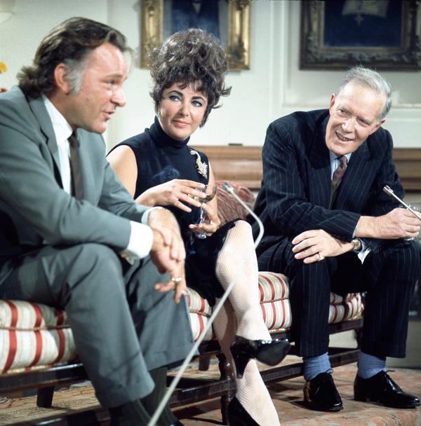 Richard Burton, Elizabeth Taylor and Neil Coghill filming an interview at Merton College, Oxford in 1967.
