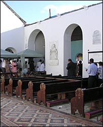 A church service goes on in a roofless church in Grenada