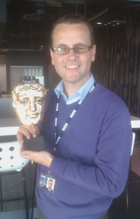 Frank Keogh, BBC sports journalist, with a BAFTA won by his department