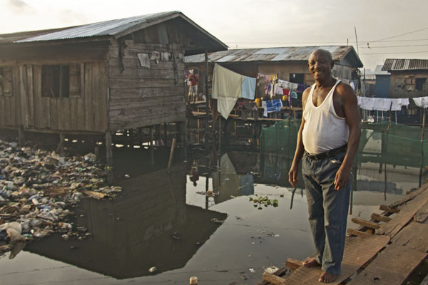Programme two's star Mr Chubbey outside his home on the floating slum of Makoko
