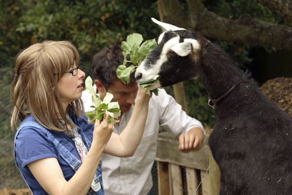 Sue Perkins and Giles Coren feeding a goat
