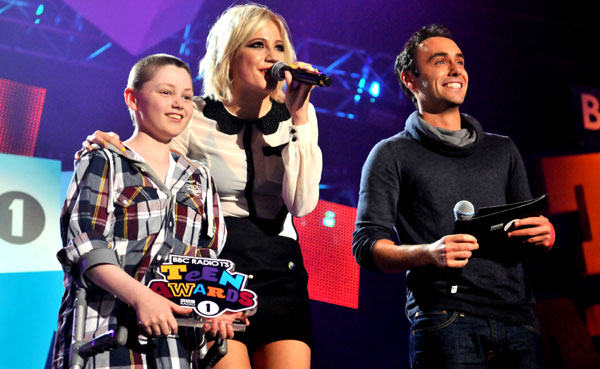 Mollie King and Aled Haydn Jones award Alec with his prize. 