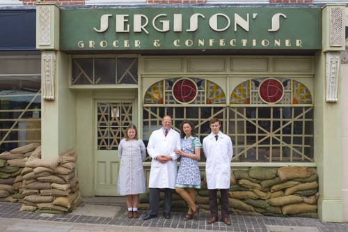Karl Sergison outside the grocer shop in the wartime era