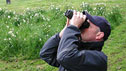 man looking through binoculars
