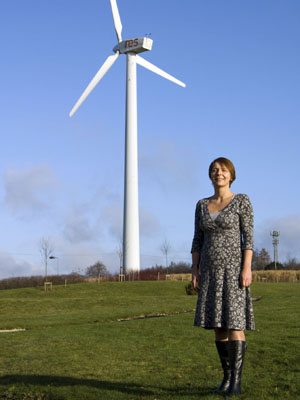 Rachel Ruffle from Renewable Energy Systems, standing by a wind turbine.