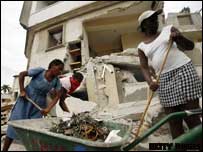women clear rubble