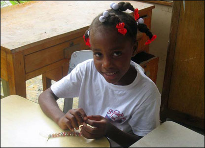 A Haitian schoolgirl doing her art work