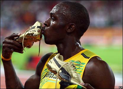 Bolt kisses his golden trainers