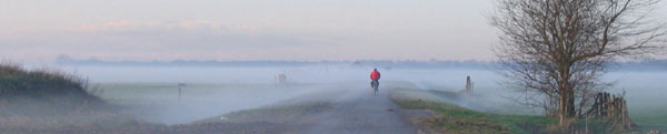 Pictiure of a cyclist in a misty landscape
