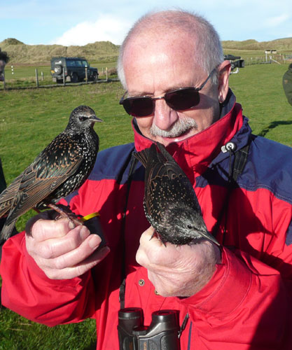 Chris Feare with tame starlings