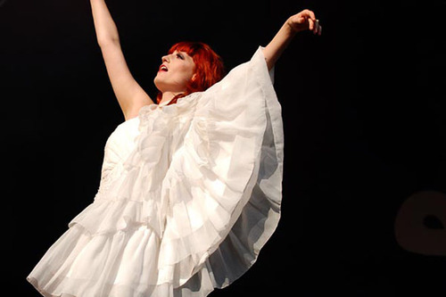 Florence Welch from Florence And The Machine dressed in all white performing at Glastonbury 2010