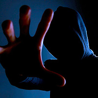 Hand reaching from hoodie