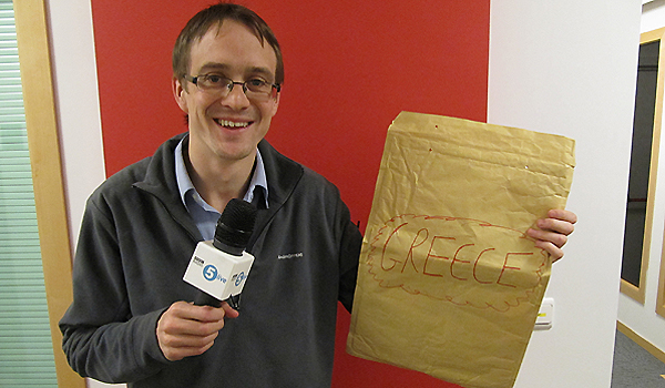 Chris Mason and his money for Greece envelope