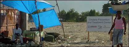 Woman walks past a cholera clinic