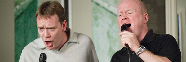 Phil and Ian sing on a karaoke machine