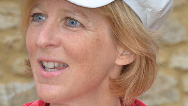 Kate Danielson smiling in a white hat