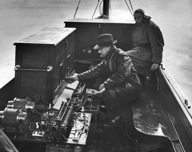 The picture shows engineers testing equipment before the broadcast of the Oxford and Cambridge boat race in 1928.