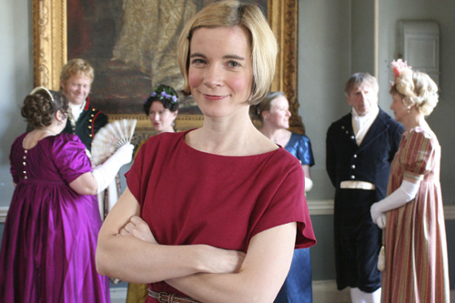 Lucy Worsley in front of group wearing Regency dress