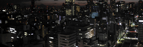 Lights are turned off to save energy before rolling blackouts in Tokyo