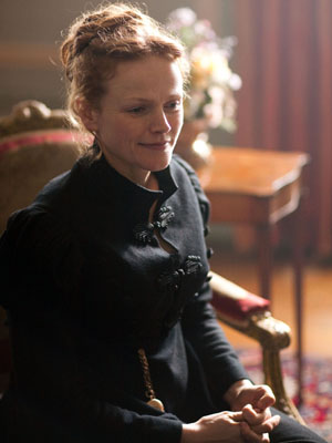 Maxine Peake, as Miss Anne Lister, sits in a chair