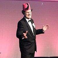Clive Mantle performing as Tommy Cooper on the Festival Cafe.