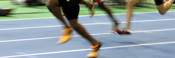 Sprinters legs blur as they race