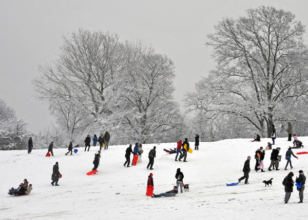 People playing in heavy snow in the park