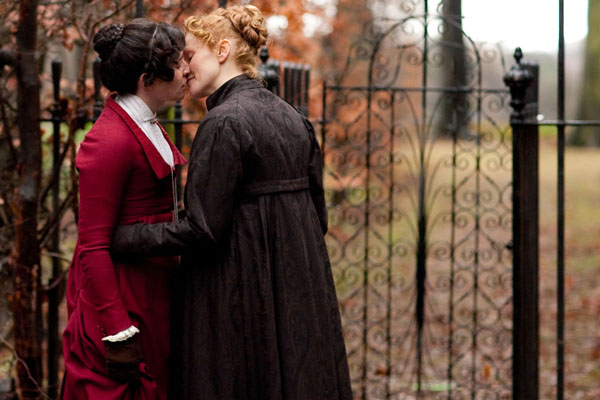 Anne Lister, played by Maxine Peake, and Tib, played by Susan Lynch share a kiss outside some gates