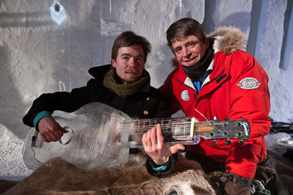 The Dutch guitarist, Bram Stadhouders, having a first go at tuning and then playing the ice guitar, as long as his fingers can bear it! Next to him, Bill Covitz, the ice carver. At the Norwegian Ice Music Festival.