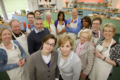 Great British Bake Off hosts Mel and Sue surrounded by the judges and contestants