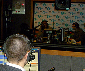 Jim talks to Dotun while Up All Night is being broadcast