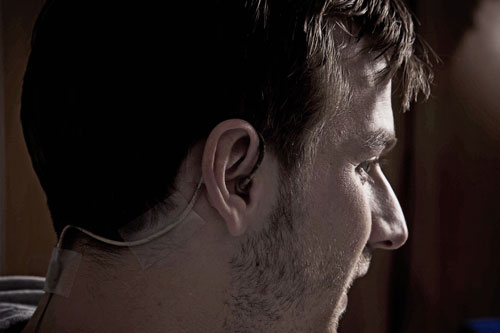 Actor Calum Callaghan wearing an earpiece