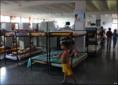 Children sleep in a school that has been converted into a shelter.