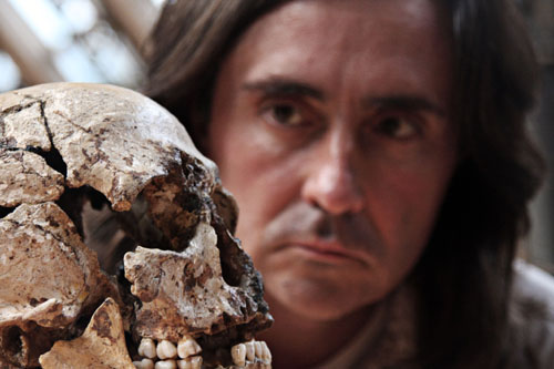 Neil Oliver looking at a skull