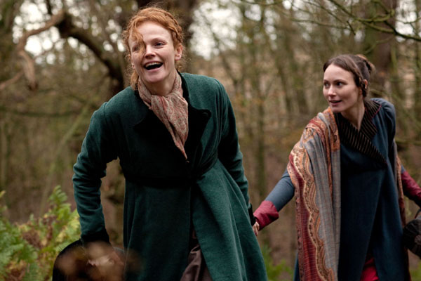 Anne Lister, played by Maxine Peake, and Marianna, played by Anna Madeley, run hand in hand through the woods
