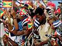Grenadian crowd waving flags during Castro visit