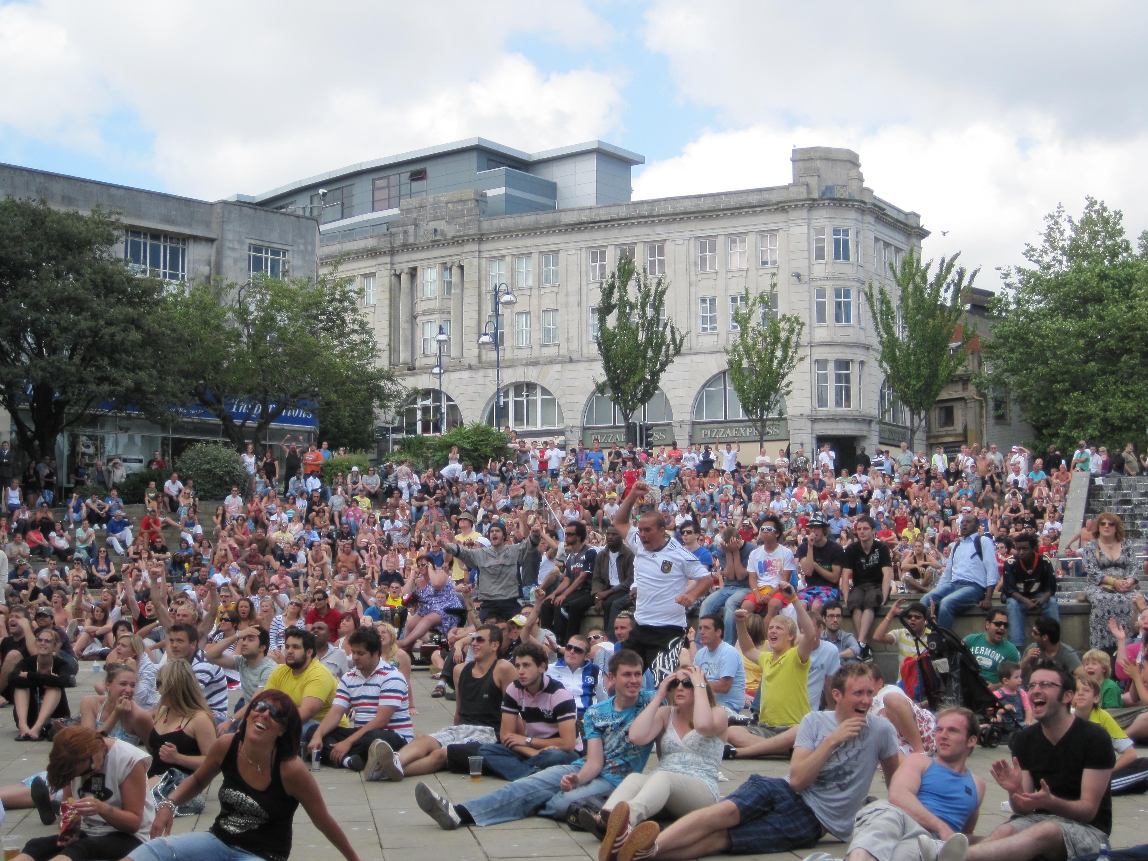 Crowd watching a football match during the World Cup in a city centre