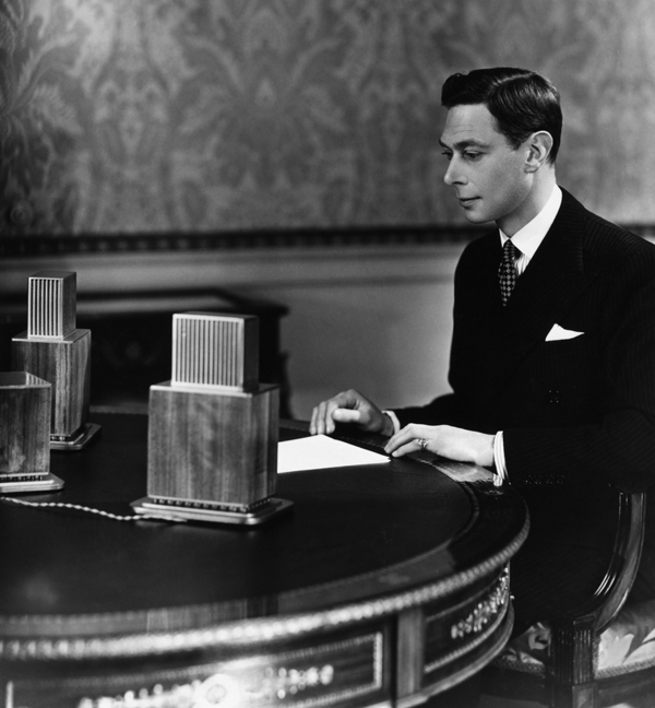 King George VI at the microphone at Buckingham Palace.