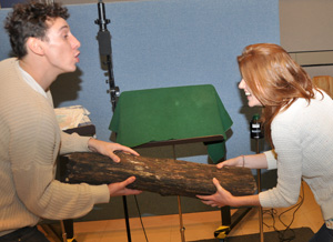 Al Weaver (Ferdinand) and Rose Leslie (Miranda) fighting over logs