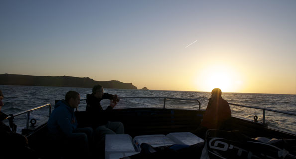 Filming on a boat at night by Dan Rees