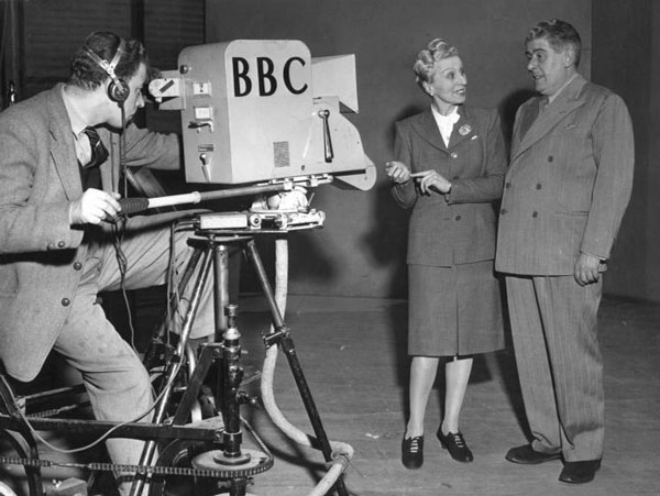 Unidentified camera man and husband and wife team Nan Kenway and Douglas Young in 1947. Original transcript from photo : Nan Kenway and Douglas Young before the television camera. BBC