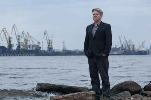 Kurt Wallander (Kenneth Branagh) stands alone in the bleak landscape
