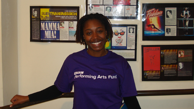 Yassmin Foster smiling in a BBC Performing Arts Fund t-shirt