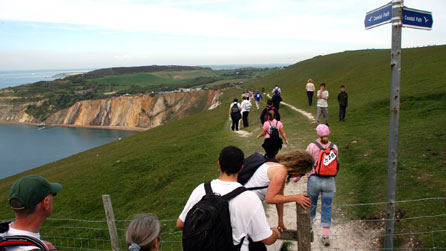 people walking on cliff top