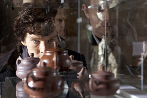 Sherlock Holmes, played by Benedict Cumberbatch, peers through a window