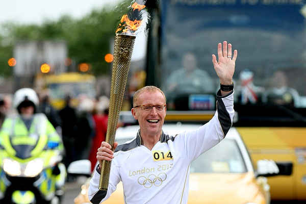 Bryan Burnett running with the Olympic Torch in Aberdeen, 12 June 2012.