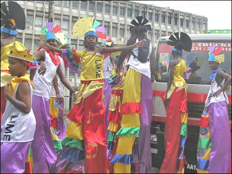children in moko jumbie costumes