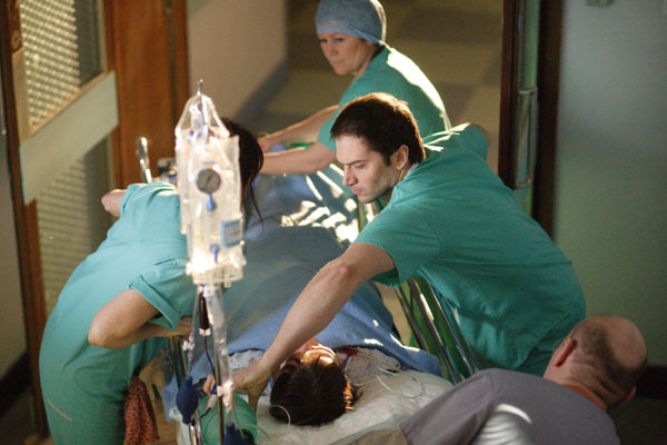 Dr Joseph Byrne, played by Luke Roberts, and Dr Connie Beauchamp, played by Amanda Mealing, rush a unconcious patient down a corridor in desperate search of a room with power