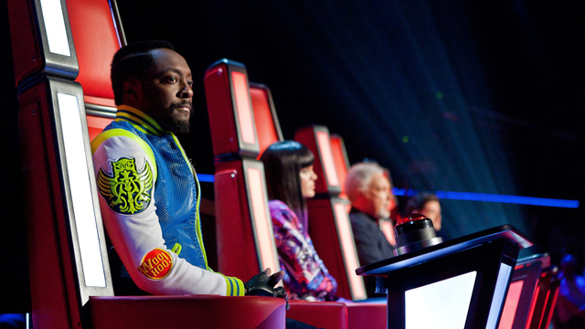 The Voice judges sit in their red chairs.